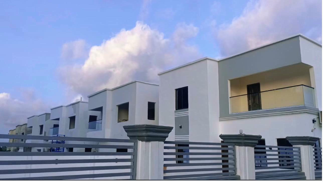 A row of completed Smart Brother homes in a Liberian neighborhood
